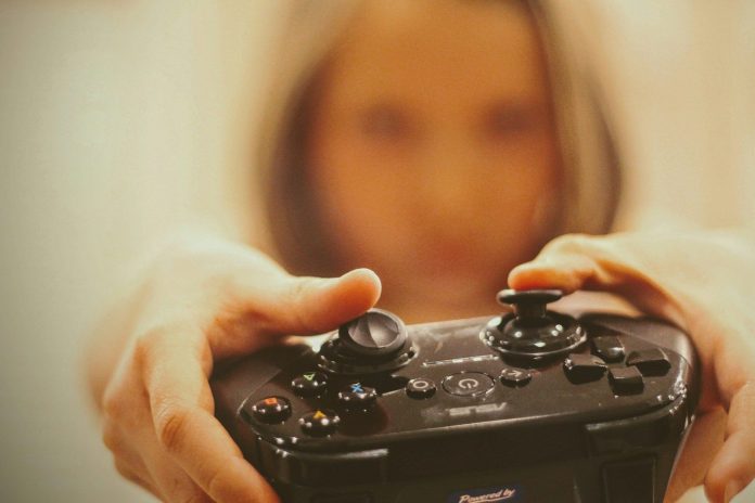 Photo by Joshua Hoehne person holding black sony ps 4 controller