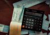 Money-Back Policy Maturity and Survival Benefits: What to Check in Your Form 26AS Download a calculator sitting on top of a wooden table