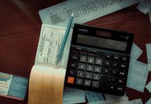 Money-Back Policy Maturity and Survival Benefits: What to Check in Your Form 26AS Download a calculator sitting on top of a wooden table