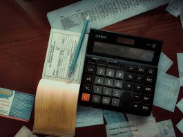 Money-Back Policy Maturity and Survival Benefits: What to Check in Your Form 26AS Download a calculator sitting on top of a wooden table