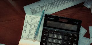 Money-Back Policy Maturity and Survival Benefits: What to Check in Your Form 26AS Download a calculator sitting on top of a wooden table