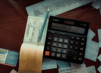 Money-Back Policy Maturity and Survival Benefits: What to Check in Your Form 26AS Download a calculator sitting on top of a wooden table