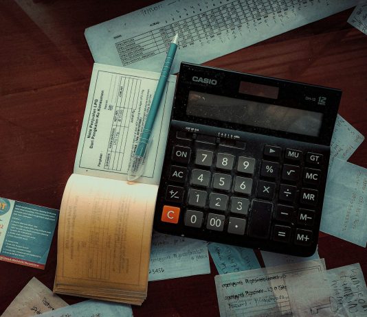 Money-Back Policy Maturity and Survival Benefits: What to Check in Your Form 26AS Download a calculator sitting on top of a wooden table