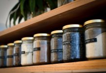 A Simple Checklist for Choosing Storage Jars from a Furniture Store in Coimbatore a shelf filled with lots of different types of spices