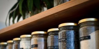 A Simple Checklist for Choosing Storage Jars from a Furniture Store in Coimbatore a shelf filled with lots of different types of spices
