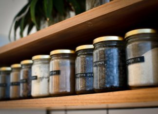 A Simple Checklist for Choosing Storage Jars from a Furniture Store in Coimbatore a shelf filled with lots of different types of spices