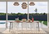 How To Match Your Home Layout To Your Lifestyle a dining room with a table and chairs next to a pool