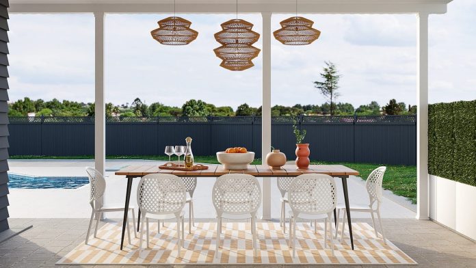 Photo by Spacejoy a dining room with a table and chairs next to a pool
