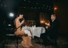 A Bayswater evening for two man sitting in front of woman holding wine glass