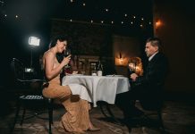 A Bayswater evening for two man sitting in front of woman holding wine glass