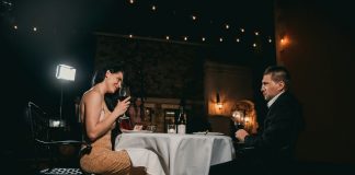 A Bayswater evening for two man sitting in front of woman holding wine glass