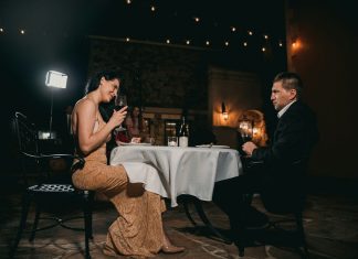 A Bayswater evening for two man sitting in front of woman holding wine glass
