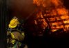 Perils Covered in Standard Fire Insurance Explained firefighter inside burning house