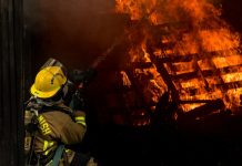 Perils Covered in Standard Fire Insurance Explained firefighter inside burning house