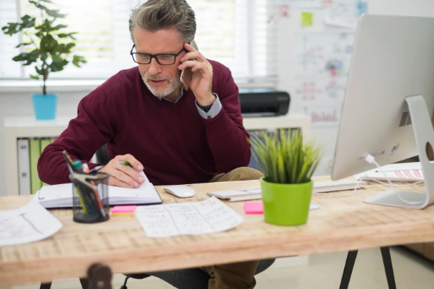 man-talking-phone-with-one-his-clients