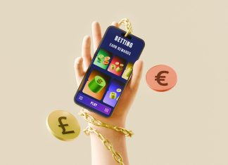Why Betting Feels Better With The Right App Hand holding phone with betting app, currency, and gold chain.