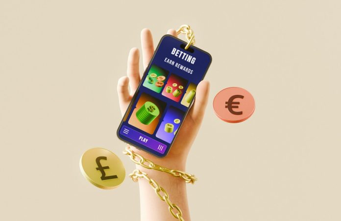 Photo by Shubham Dhage Hand holding phone with betting app, currency, and gold chain.