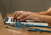 Professional Indemnity Insurance for Doctors: Protection Against Medico-Legal Risks person sitting while using laptop computer and green stethoscope near