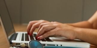 Professional Indemnity Insurance for Doctors: Protection Against Medico-Legal Risks person sitting while using laptop computer and green stethoscope near